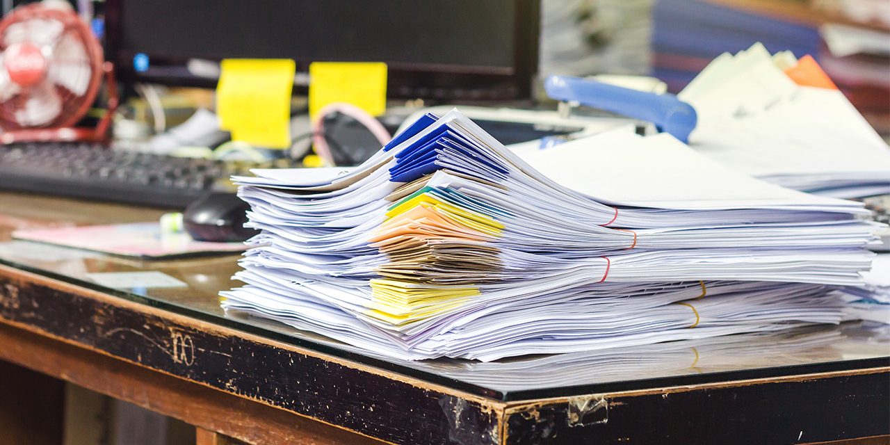 stack of folders and documents on office table